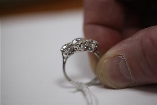 A platinum and three stone diamond ring, size M.